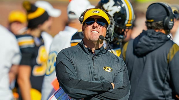 Missouri coach Eli Drinkwitz checks the clock during the Tigers' game against Arkansas.